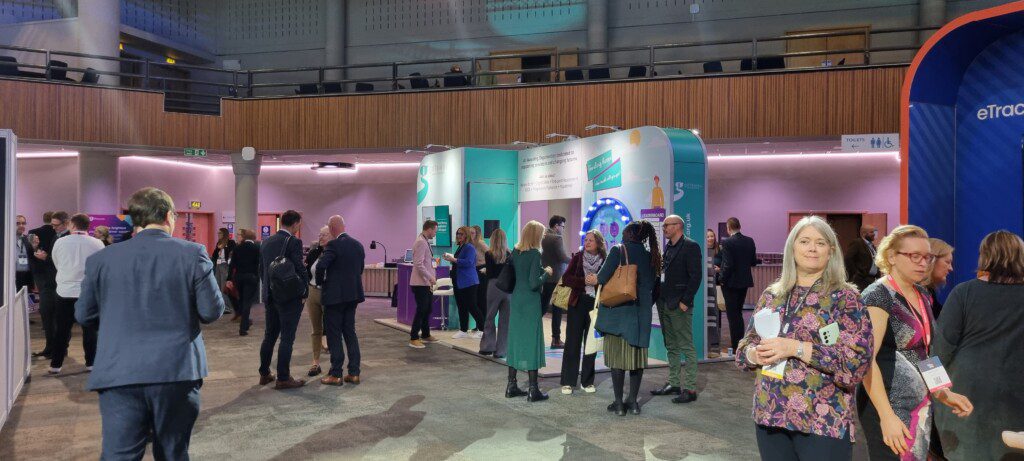 Crowded exhibiton hall with Gateway Qualifications stand visible in the background