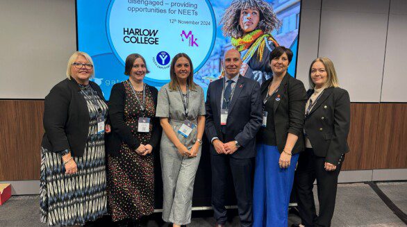 Group of workshop presenters from Youth Employment UK, Harlow College and Milton Keyenes College in front of screen at AoC Conference.